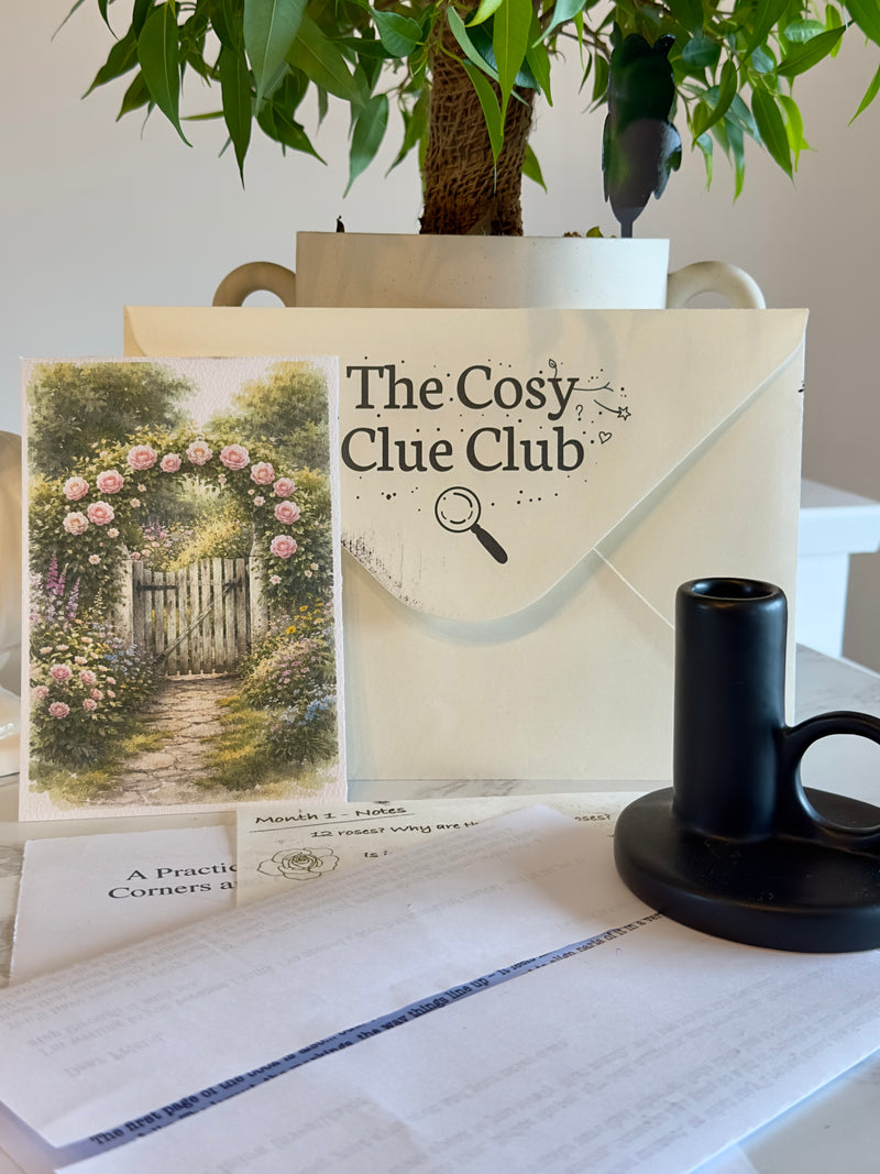 The Cosy Clue Club package with a mug and stationery on a table